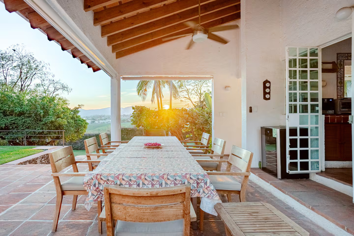 Terraza con mesa larga al atardecer en la propiedad